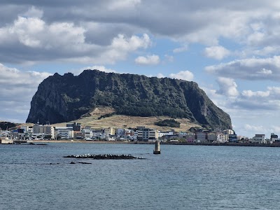 城山日出峰の壮大な火山錐と海
